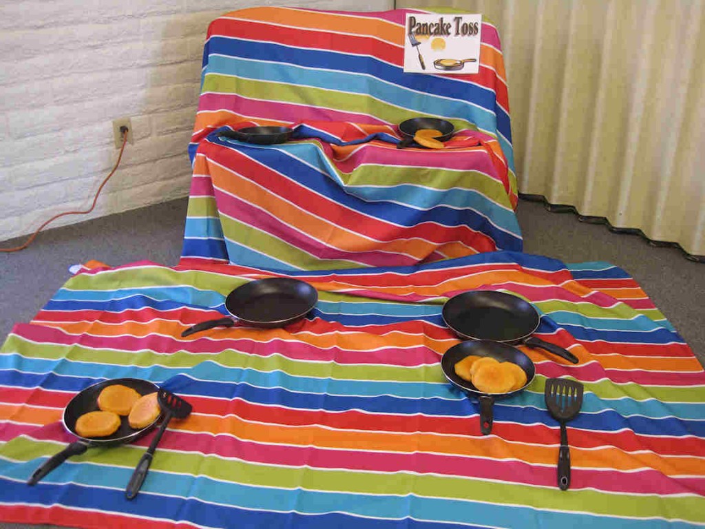 Pancake Toss Game Lady Behind the Curtain