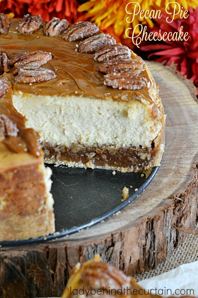 Pecan Pie Cheesecake | A layer of pecan pie filling with a creamy cheesecake center topped with caramel and sugared pecans.