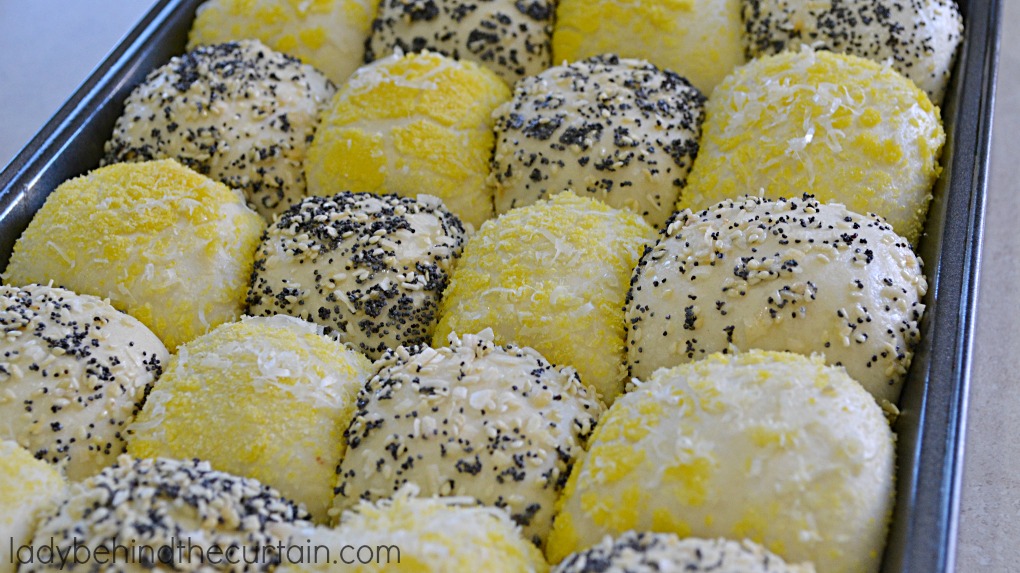 Semi Homemade Checkerboard Rolls | Tender tasty rolls. Some of the rolls have been rolled in seeds, minced onions while the other half of the rolls are rolled in corn meal and Romano cheese. Now that's a tasty roll!