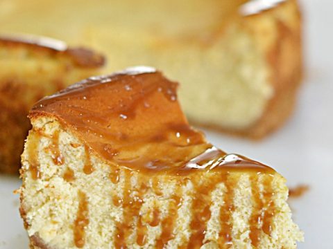 Rum Caramel Drizzled Eggnog Cheesecake | When two holiday favorites come together and make the most delicious dessert; that is elegant enough to grace any Christmas dessert table!