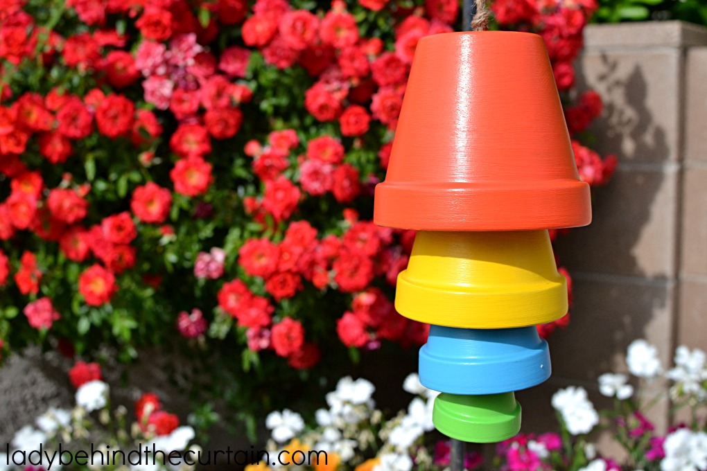 DIY Clay Pot Chimes | Add a pop of color to your backyard with these easy to make chimes. So much Summertime fun!