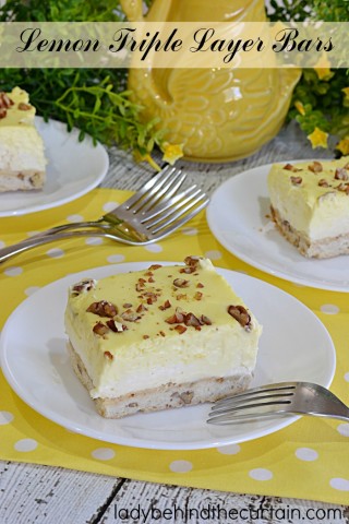 Lemon Triple Layer Bars | You'll have your guests Ooooing and Awwwwing when you bring some sunshine to your table with these easy to make light and fluffy bars!