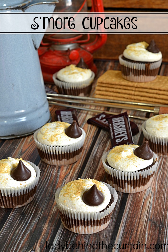 Easy S'more Cupcake Recipe | Bring back childhood memories of sitting around the campfire singing songs and roasting marshmallows with these fun easy to make cupcakes. They are my absolute favorite cupcakes. I love the graham cracker bottom and the marshmallow frosting is simply the best! You don't have to be a professional baker to make something out of this world delicious.