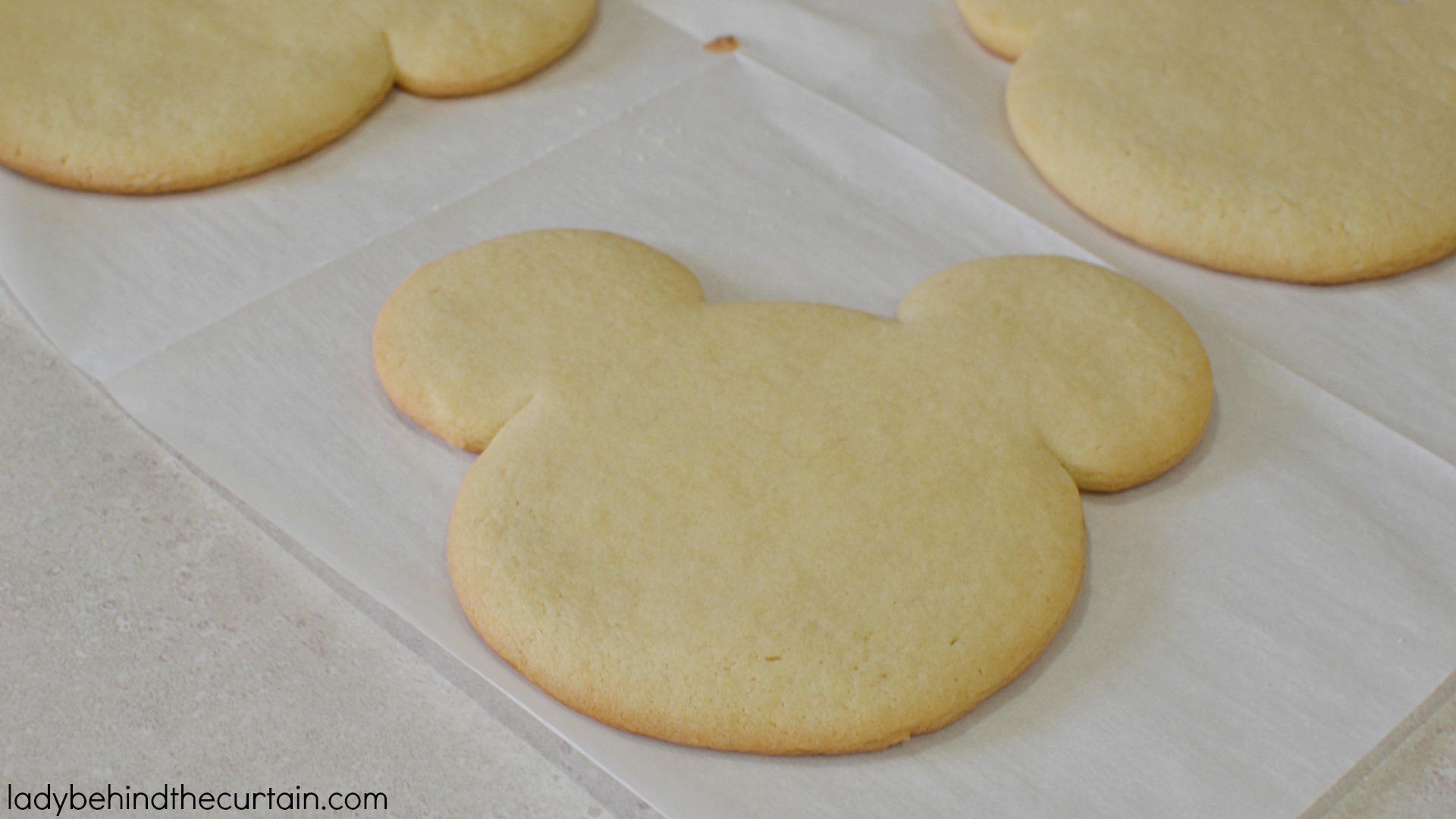 Copycat Disneyland Mickey Mouse Sugar Cookies | These giant cookies have a delicious butter flavor with just the right amount of softness and dipped in melted candy.