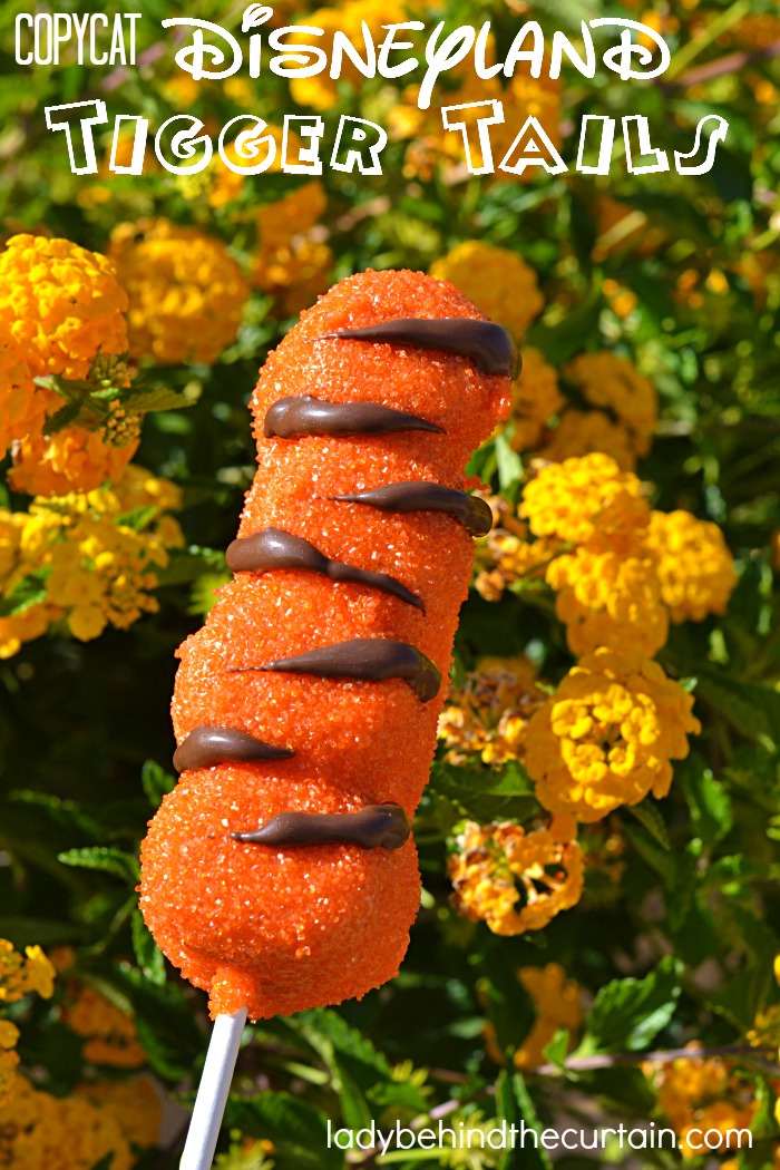 Copycat Disneyland Tigger Tails | Four large marshmallow stacked together, dipped in caramel, melted candy, sprinkled with orange sugar and a drizzle of dark chocolate. 