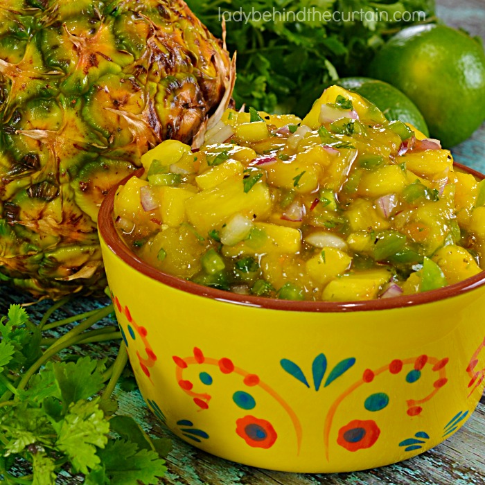 Apricot Pineapple Salsa | The perfect blend of sweet and spicy.  This easy to make salsa will take whatever you serve it with up to the next level.  With big chunks of fresh pineapple, apricot preserves and the salsa favorites of cilantro, lime juice, jalapeno and a few other ingredients you better make sure you double the recipe!