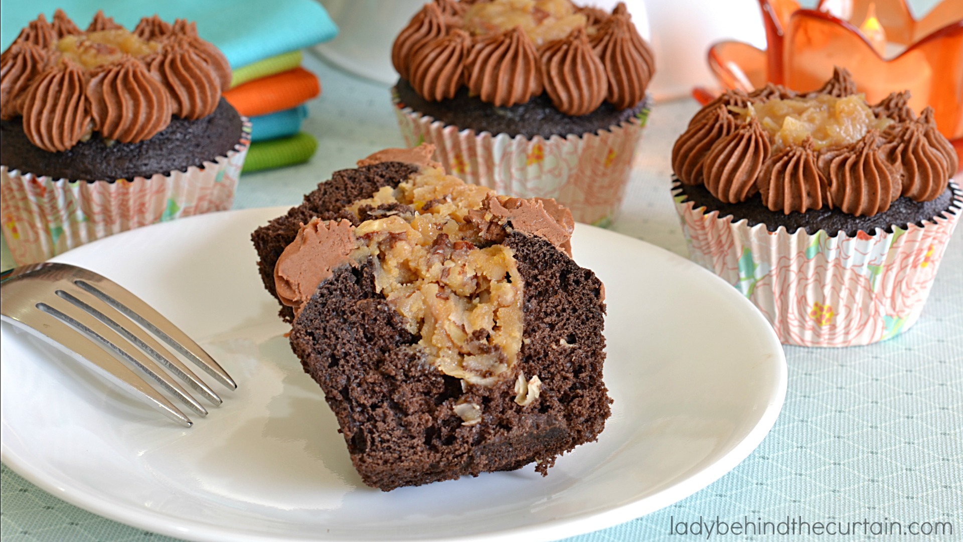 German Chocolate Cupcakes | A deep chocolate cupcake filled with the delicious coconut frosting that we all love along with a creamy butter chocolate frosting.  The perfect chocolate cupcake!