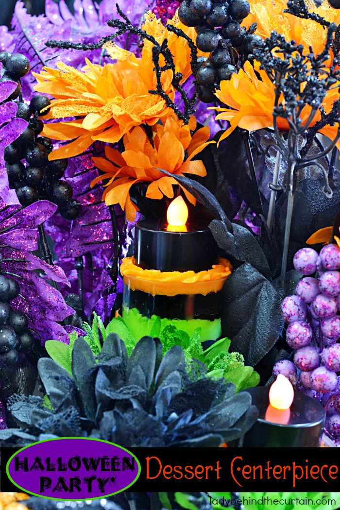 Halloween Party Dessert Centerpiece | This colorful centerpiece doubles as dessert! If you look closely you will see push up pops tucked in the arrangement. Perfect for Halloween!