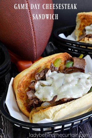 Game Day Cheese Steak Sandwich | This sandwich is piled high with roast beef, peppers and onions but the star of the show is the creamy cheese.