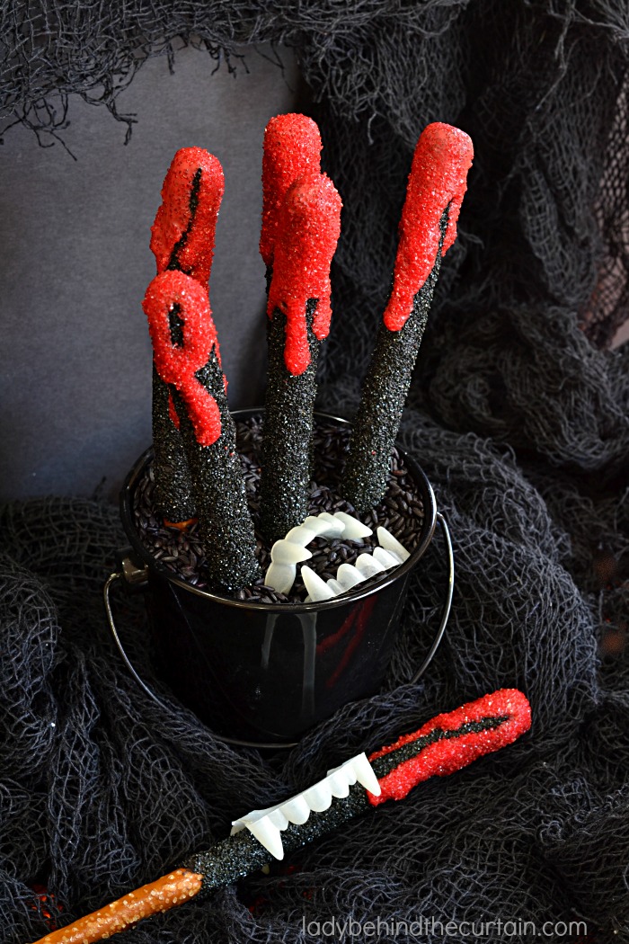 Halloween Vampire Pretzels | These bloody creations are perfect for any scary themed Halloween Party. With the perfect balance of sweet and salty no one with care that there is blood dripping down their pretzel.