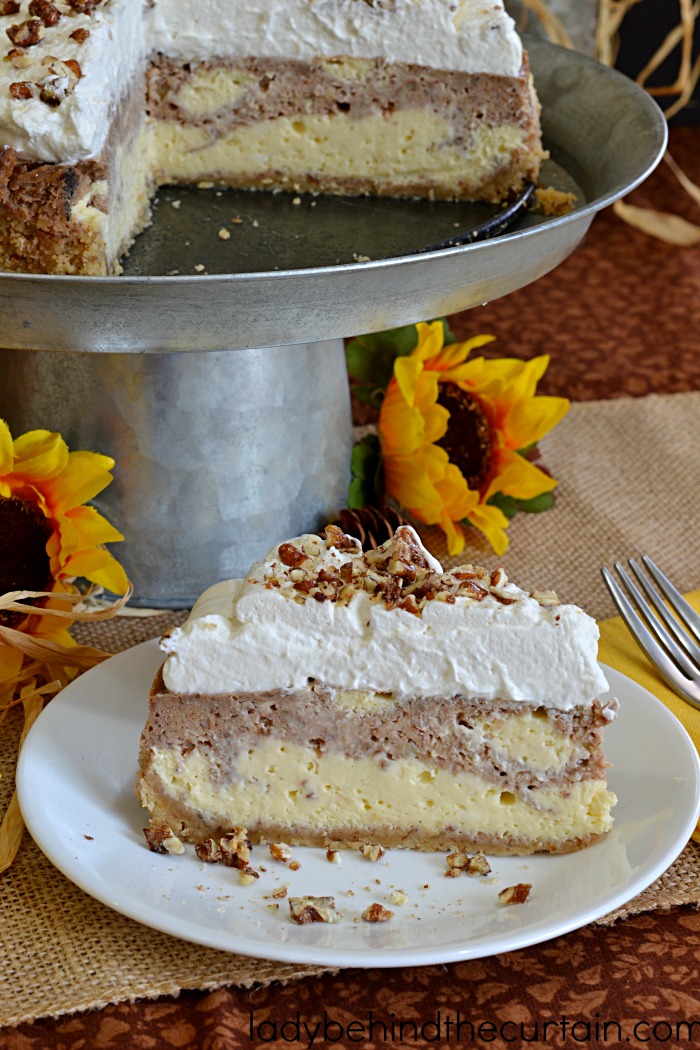 Roasted Banana Pecan Cheesecake | The base of this incredible cheesecake is marbled with mashed roasted bananas and also topped with light and fluffy homemade pecan whipped cream. I'd call that a holiday on a plate!