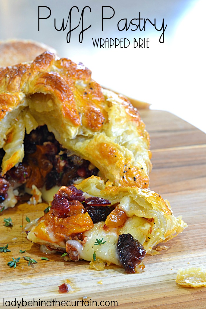 Puff Pastry Wrapped Brie | Every Appetizer table needs a wheel of brie! This creamy cheese with is piled high with dried fruit and nuts all encased with a crispy puff pastry.